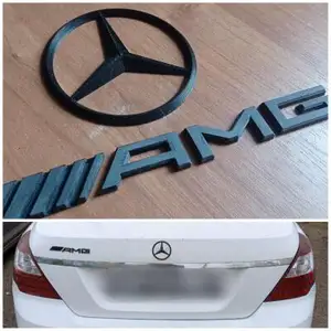 Логотип Mercedes и шильдик AMG на а...