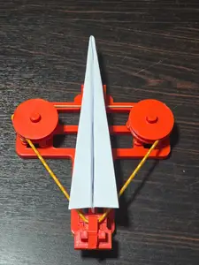 Rubber band paper plane launcher