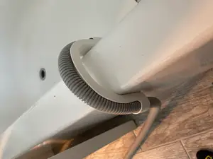 Bathtub portable washing machine drain hose holder