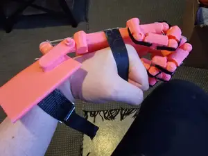 Wrist actuated prosthetic arm