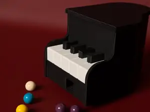 Piano gum ball dispenser