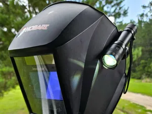 Welding hood flashlight holder