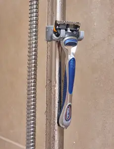 Razor holder for shower rail