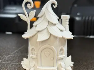 A house in a tree stump with a leafy roof