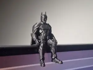 Batman Figure Sitting on a ledge