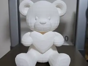 Bear holding heart statue