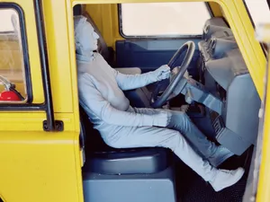 Car driver male one hand on wheel