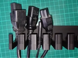 Door mounted cable storage hanger for mains cables
