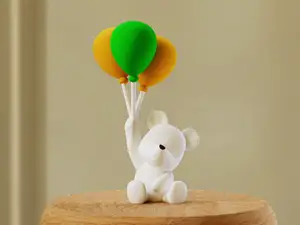 Polar bear holding balloons