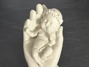 Hand Holding a Baby  Symbol of Love and Protection