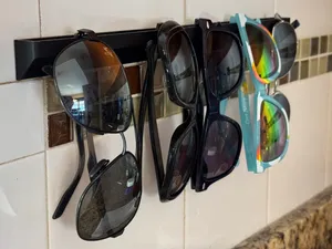 Wall mounted sunglasses holder