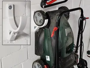 Wall mounting for lawn mowers or scarifiers