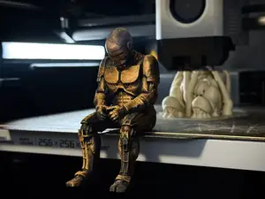 Sad RoboCop figurine sitting on a ledge!