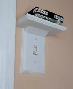 Light switch cover, featuring a built-in shelf