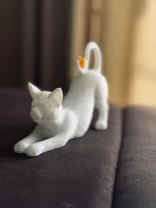 Stretching Cat with Bird on Tail