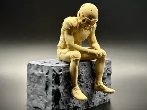 Sad NFL Football Player sitting on ledge figurine