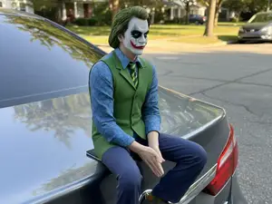 Joker sitting on rear trunk lid or shelf 