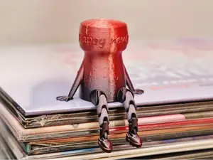 Champagne cork with articulated legs