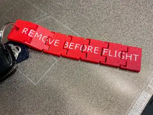 Hinged Flexi Remove Before Flight Keychain Tag