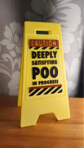 wet floor sign poo in progress