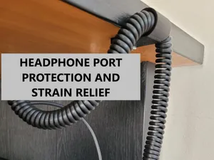 Coiled headphones cable holder and strain relief