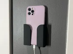 Wall mounted phone holder