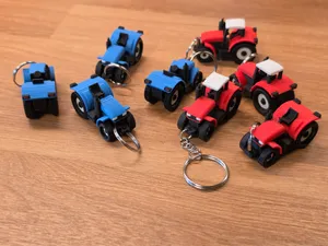 Mini tractor keychain with movable wheels