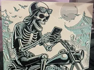 A Skeleton with Mobile on Motorcycle