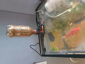 Automatic fish feeder with bottle hopper and SG90 Adapter