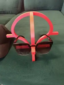 A stand for a baseball cap and glasses