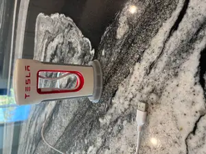 Type-C/Lightning Tesla SuperCharger Phone Charger with larger hole for charger to fit through.