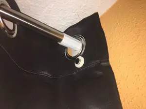 Cloth curtain bar holder with magnetic end.