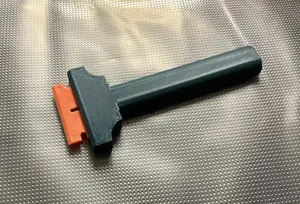 Scraper with replaceable dual sided plastic blades