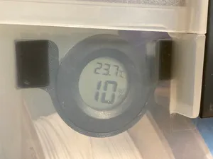 Drop-in holder for round humidity/temperature gauge in a drybox