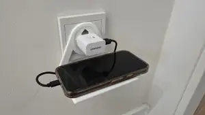 Mobile phone holder plugged into a European socket