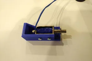 Bracket to mount solenoid for Virtual pinball machine force feedback.