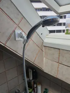 Adjustable shower head holder