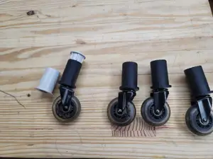 old - Roller caster support for a plastic shelf unit - old