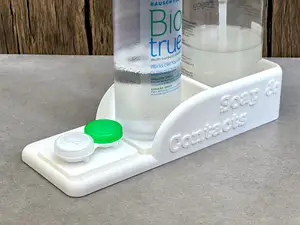 Bathroom organiser tray for a soap dispenser, contact lens liquid and case