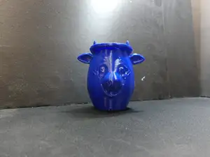 A cow face flower pot for plants.