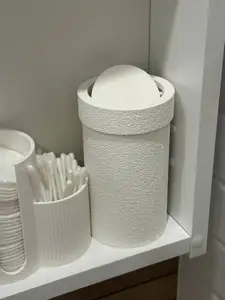 Small trash can with a rotating lid