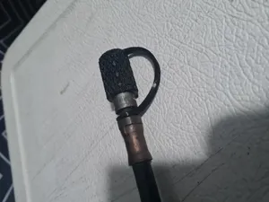 Vad Che's grease gun cap with a strap