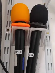Wall bracket for a wireless hand microphone