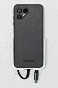 Outlet mounted phone charging stand
