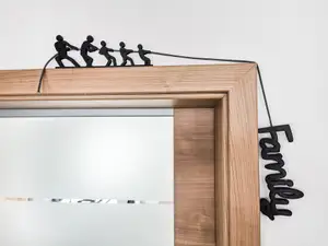Family pulling the rope - door frame decoration