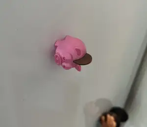 Piggy bank magnet with a coin