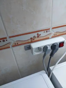 Extension cord wall holder