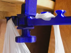 Thumbscrew for eco-friendly deskside trash bags holder
