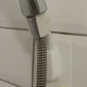 Bracket part of an adjustable 360° shower head holder
