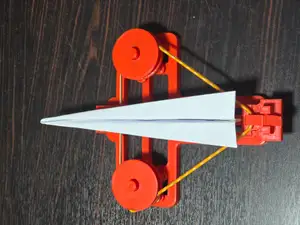 Rubber band paper plane launcher